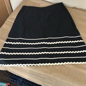 Michael Kors black slight A-line fit skirt w unique botttom white ribbon trim.